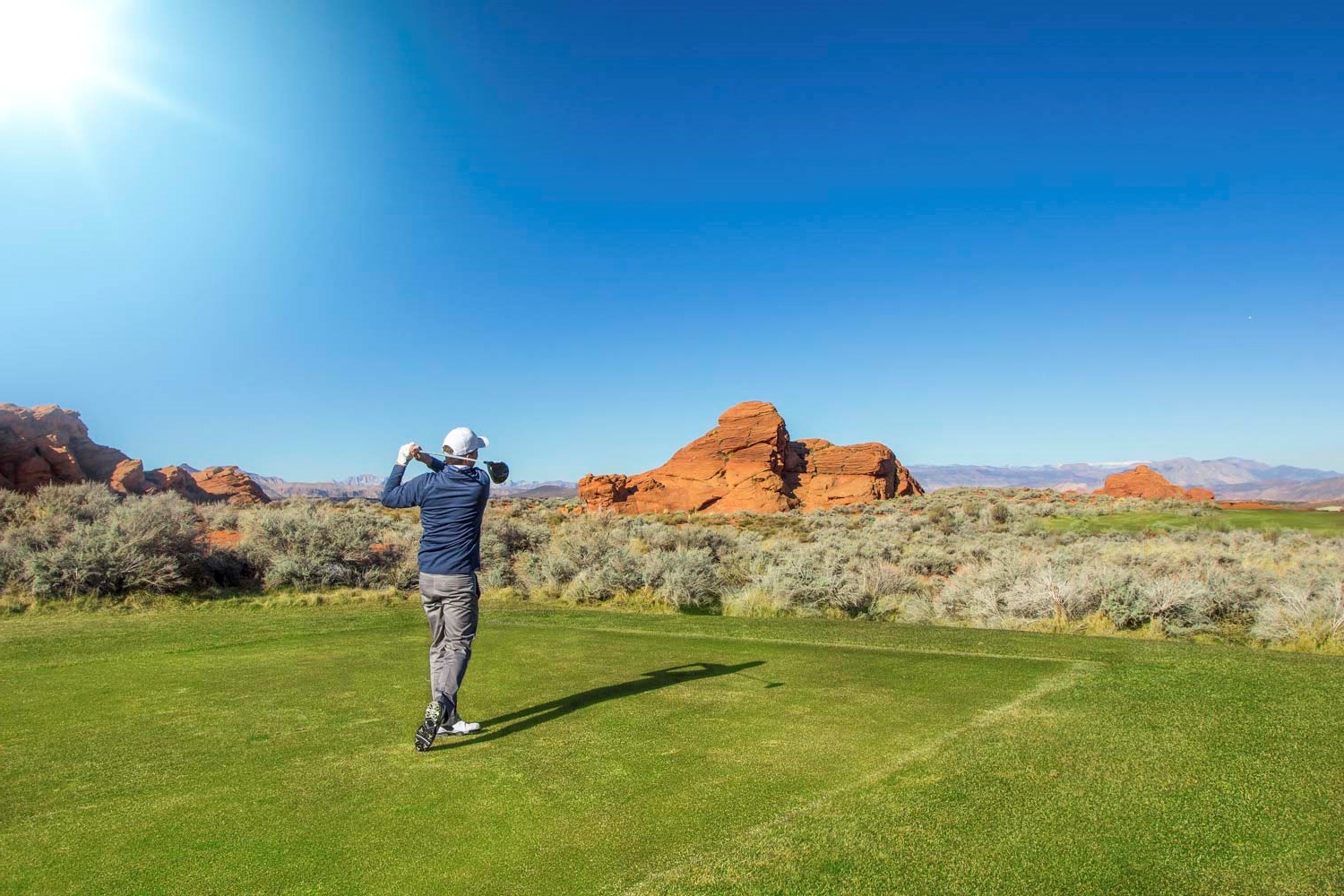 rear view of a man playing golf on a sunny day Apache junction rv parks